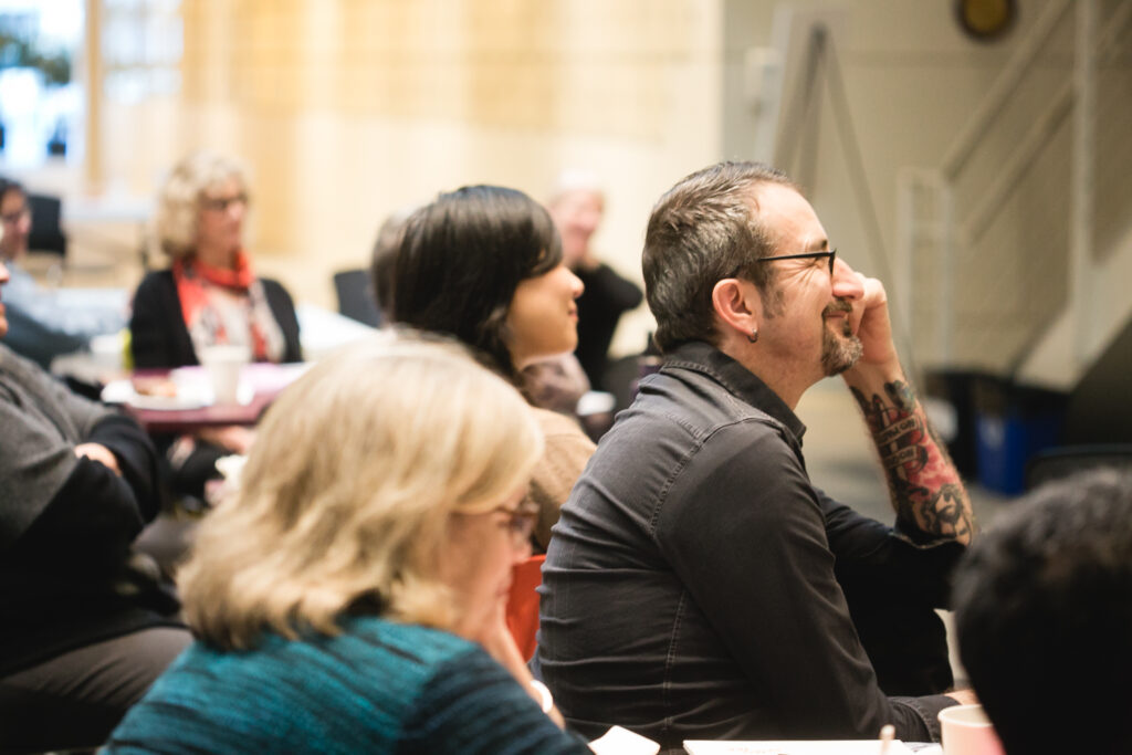 A group of teachers listening to a presentation