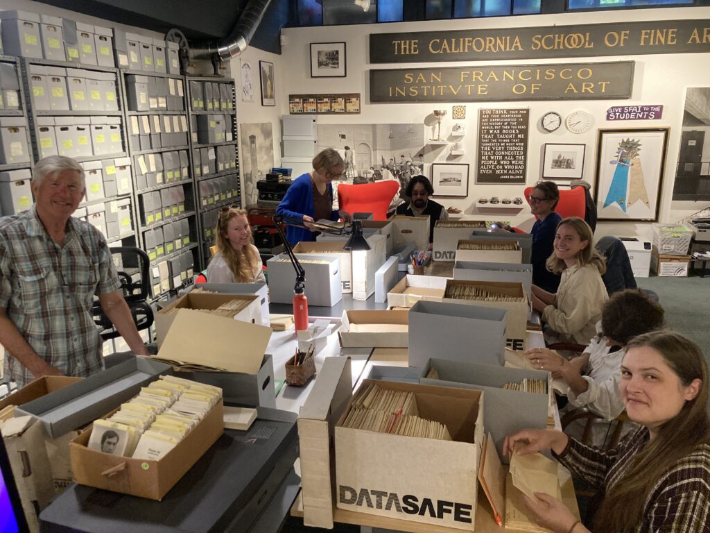 A group of librarians and archivists organize boxes of materials at the SFAI Legacy Foundation + Archive