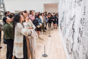 A group of visitors observing an artwork in Art in China