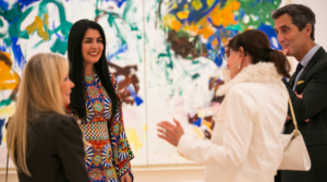 A group of adults stands in front of Joan Mitchell's Bracket